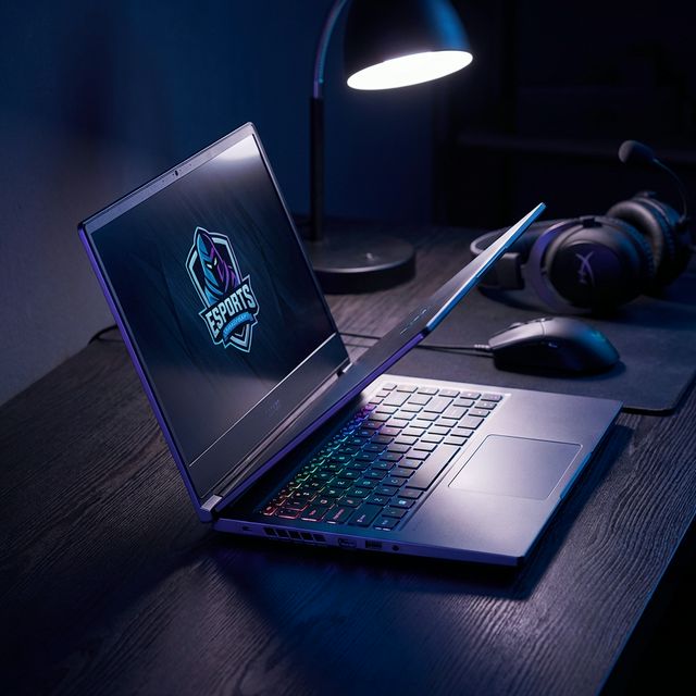 Modern gaming laptop with RGB keyboard on dark desk